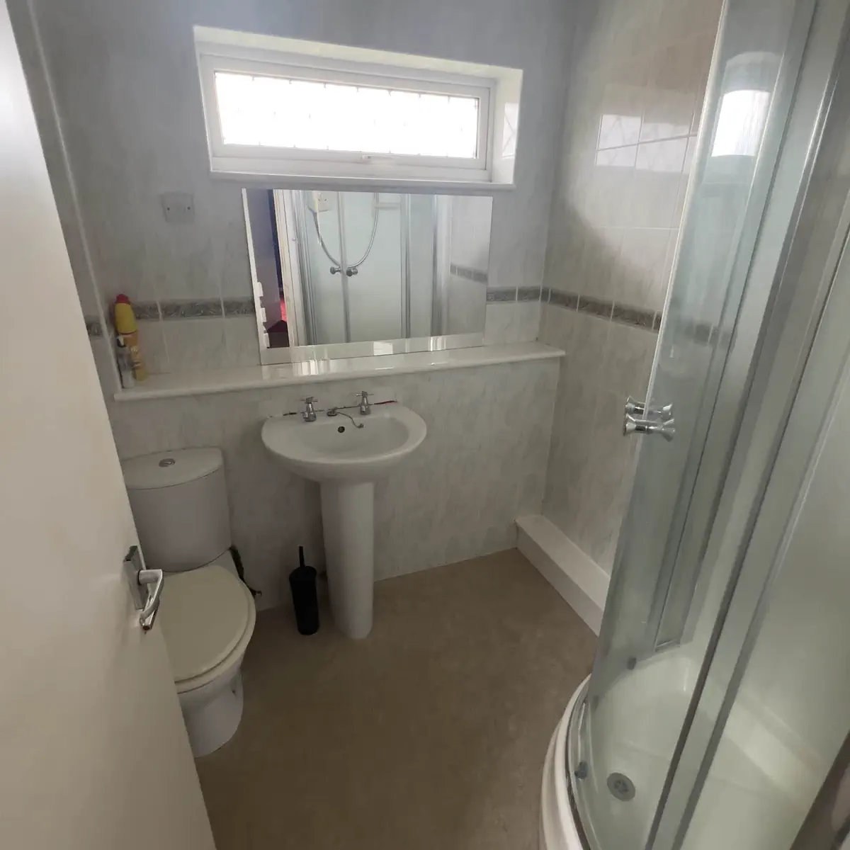 Stripping out the old shower and fixtures during bathroom demolition