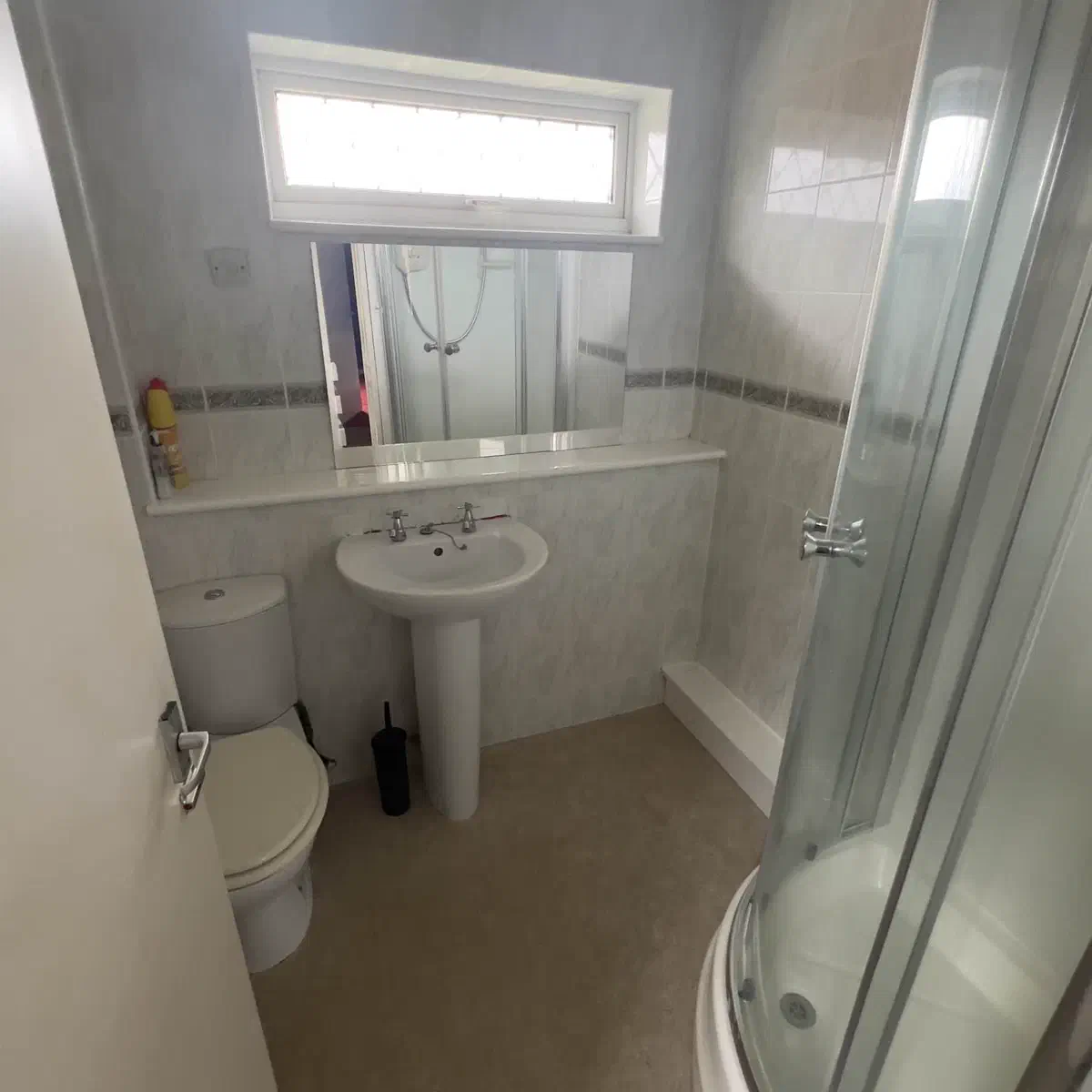 Stripping out the old shower and fixtures during bathroom demolition