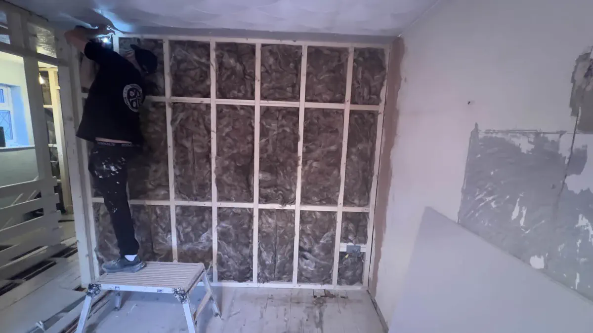 Sound insulation fitted inside stud wall cavities before plasterboard installation